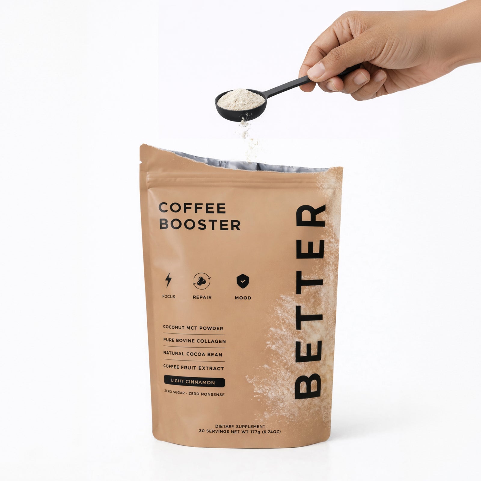 An open Better Coffee Booster pouch with a hand pouring a scoop